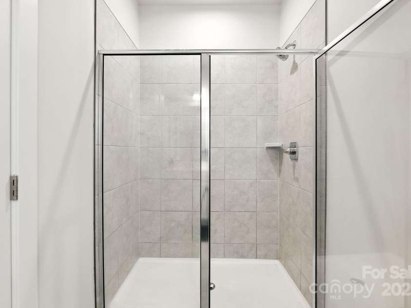5112 Larewood Drive, Harrisburg, NC 28215.  MLS# CAR4297584, YatesRealty ID 35281. Tiled Primary Bathroom Shower