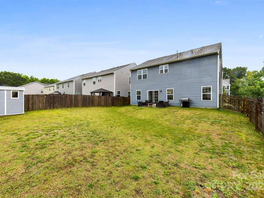 1022 Hinson Forest Road, Indian Trail, NC 28110.  MLS# CAR4264968, YatesRealty ID 35289. Flat backyard with storage shed
