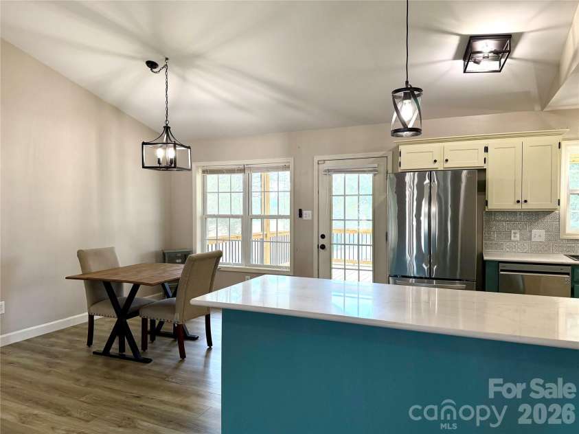1027 Tabor Road, Olin, NC 28660.  MLS# CAR4399762, YatesRealty ID 35295. Bar area and dining area