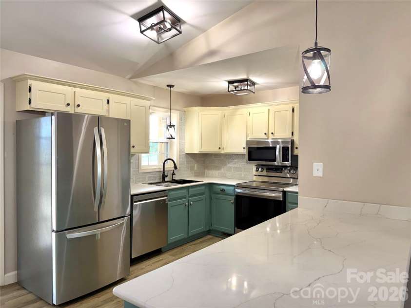 1027 Tabor Road, Olin, NC 28660.  MLS# CAR4399762, YatesRealty ID 35295. Bar area into kitchen