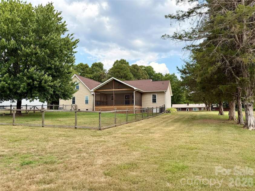 1027 Tabor Road, Olin, NC 28660.  MLS# CAR4399762, YatesRealty ID 35295. Large backyard with fenced area