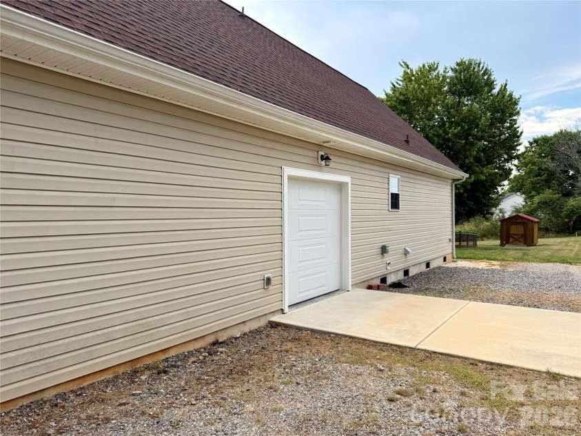 1027 Tabor Road, Olin, NC 28660.  MLS# CAR4399762, YatesRealty ID 35295. Side garage, concrete pad, camper hookup