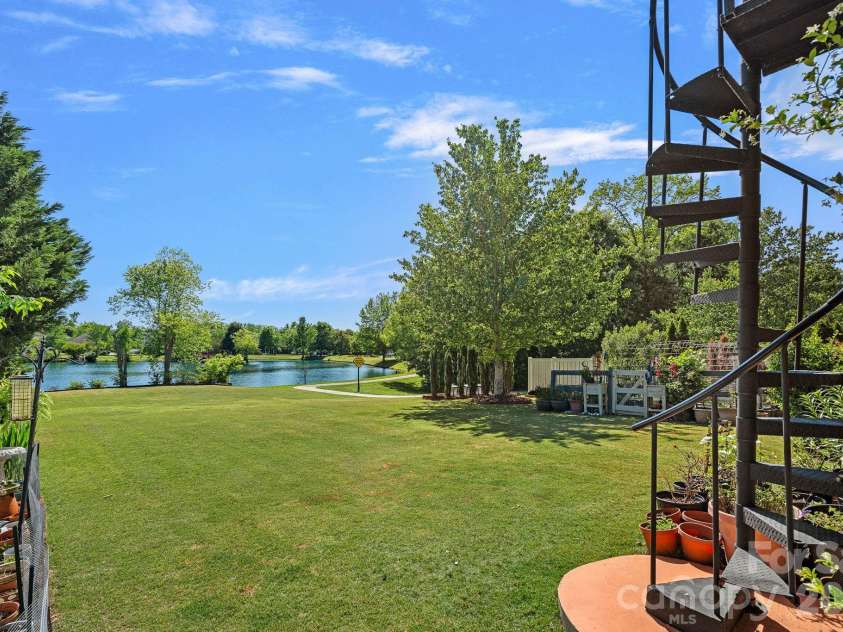 8220 Ruby Valley Road, Charlotte, NC 28277.  MLS# CAR4373964, YatesRealty ID 35304. Spiral Staircase from Balcony to Covered Patio/Pond View