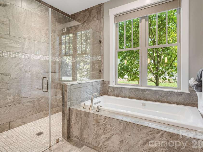 60 Barnrock Drive, Mills River, NC 28759.  MLS# CAR4399294, YatesRealty ID 35309. Primary Bathroom with Tiled Walk-In Shower and Soaking Jetted Tub