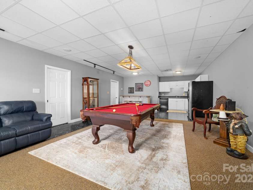 825 Ed Hamrick Road, Shelby, NC 28150.  MLS# CAR4239621, YatesRealty ID 3533. Lower level recreation room with full kitchen.