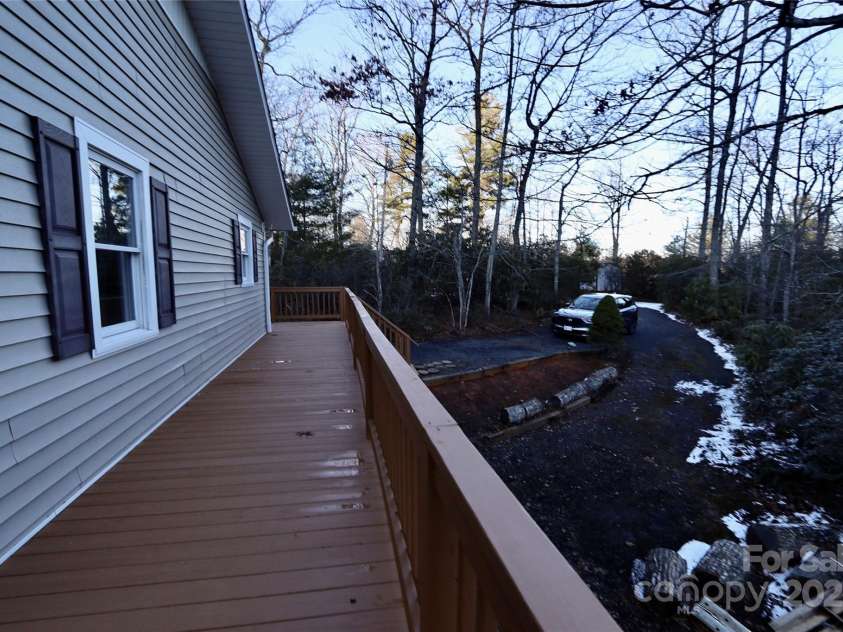 249 Cherry Hollow Road, Burnsville, NC 28714.  MLS# CAR4322750, YatesRealty ID 3536. Decking Around Two Sides of Home.