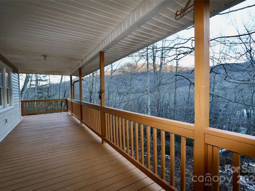 249 Cherry Hollow Road, Burnsville, NC 28714.  MLS# CAR4322750, YatesRealty ID 3536. Huge, Covered Porch with Views into the Trees and Mountains Beyond.
