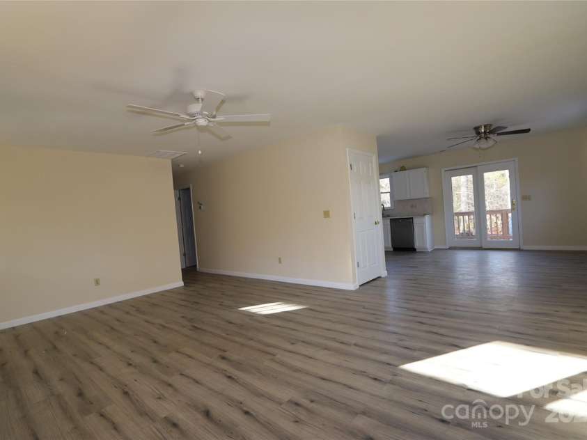 249 Cherry Hollow Road, Burnsville, NC 28714.  MLS# CAR4322750, YatesRealty ID 3536. Living Room to Dining Area & Kitchen.