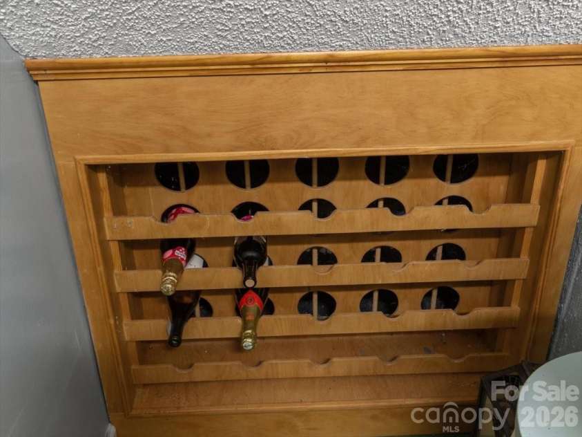 1355 Moonshine Mountain Road, Burnsville, NC 28714.  MLS# CAR4400046, YatesRealty ID 35360. Wine Storage Underneath the stairs