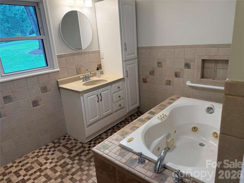 32 Mayfair Drive, Candler, NC 28715.  MLS# CAR4392323, YatesRealty ID 35365. Lower level bathroom.