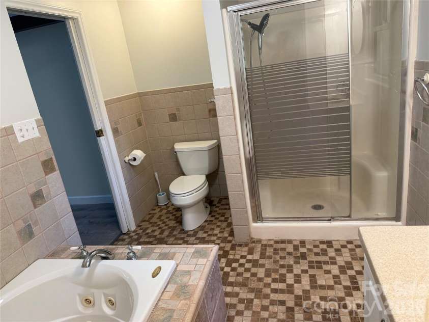 32 Mayfair Drive, Candler, NC 28715.  MLS# CAR4392323, YatesRealty ID 35365. Lower level bathroom.