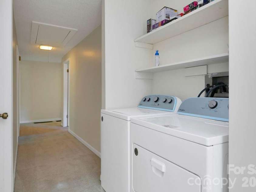 100 Kilpatrick Street, Brevard, NC 28712.  MLS# CAR4382761, YatesRealty ID 35369. Laundry located in hall adjacent to primary bedroom