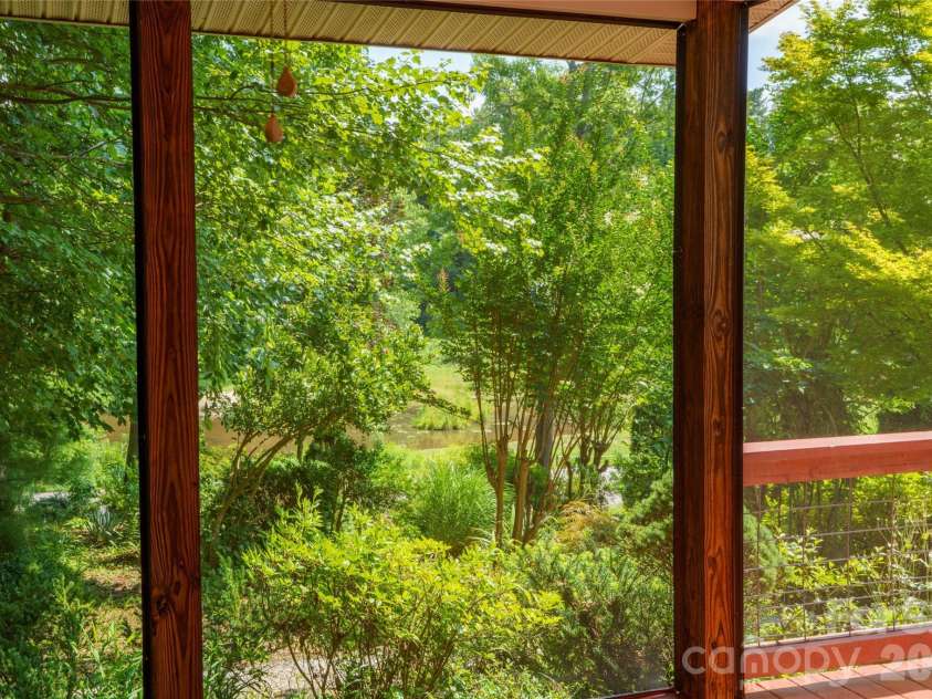 847 Lakeside Drive, Hendersonville, NC 28739.  MLS# CAR4398073, YatesRealty ID 35381. Lake Osceola through the trees