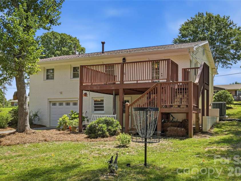520 Eastway Avenue, Kannapolis, NC 28083.  MLS# CAR4396055, YatesRealty ID 35385. Spacious backyard with a large deck accessed from the back yard and the primary bedroom.
