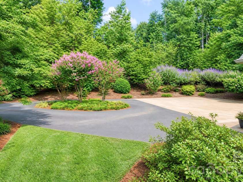 2086 Warrior Fork Trail, Morganton, NC 28655.  MLS# CAR4397825, YatesRealty ID 35399. Circular driveway, with vitex trees lining the far side