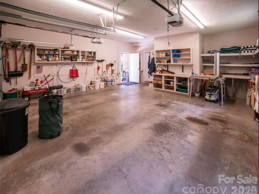 2086 Warrior Fork Trail, Morganton, NC 28655.  MLS# CAR4397825, YatesRealty ID 35399. Garage features two-car parking and workspace for gardening or projects. Outside is a concrete parking pad for a boat? Or use as a patio? You decide.