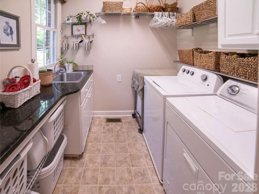 2086 Warrior Fork Trail, Morganton, NC 28655.  MLS# CAR4397825, YatesRealty ID 35399. Laundry Day has never looked like this before! Enjoy pleasant views of your private front yard and porch while you attend hummingbird feeders...or laundry