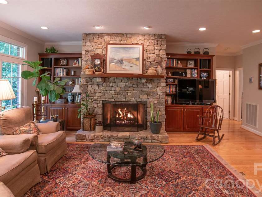 2086 Warrior Fork Trail, Morganton, NC 28655.  MLS# CAR4397825, YatesRealty ID 35399. The great room features built-in shelving and a gorgeous stone fireplace with gas logs for enjoying a fire anytime of the year
