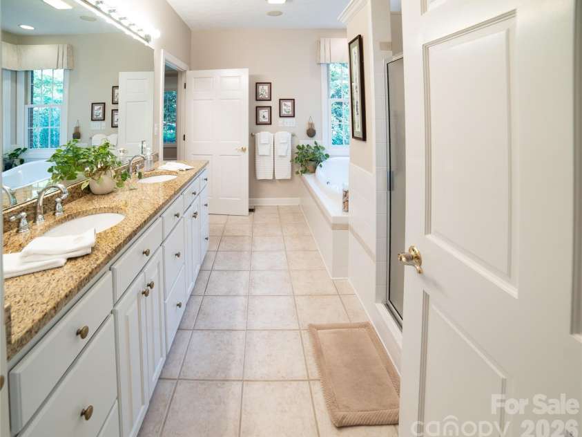 2086 Warrior Fork Trail, Morganton, NC 28655.  MLS# CAR4397825, YatesRealty ID 35399. The primary suite bathroom has a garden tub, separate shower, double vanities and all the storage you could dream of