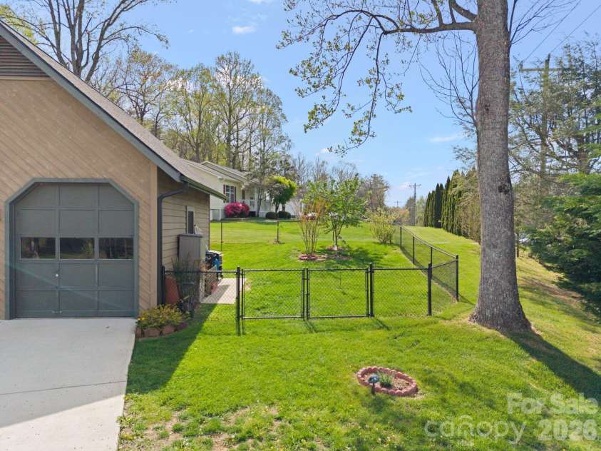 100 Forest Park Drive, Hendersonville, NC 28792.  MLS# CAR4400855, YatesRealty ID 35434. Fully fenced back yard with gate for mower access.