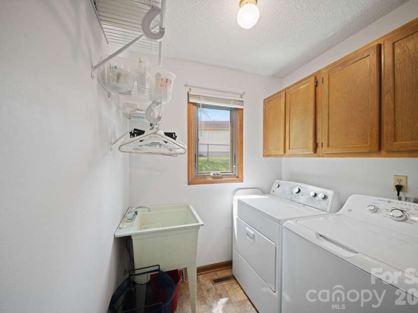100 Forest Park Drive, Hendersonville, NC 28792.  MLS# CAR4400855, YatesRealty ID 35434. Laundry with utility sink on main level