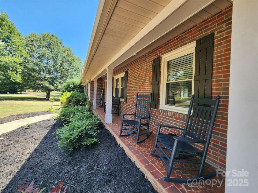 4022 Lynn Circle, Shelby, NC 28152.  MLS# CAR4284820, YatesRealty ID 35436. Rocking chair front porch