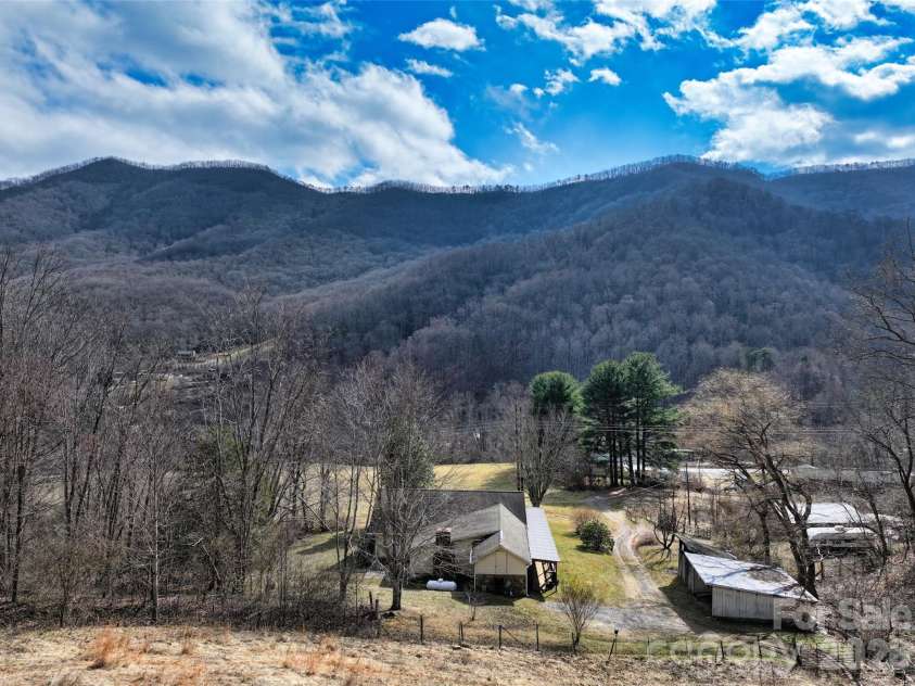 1567 Newfound Road, Leicester, NC 28748.  MLS# CAR4214973, YatesRealty ID 35448. Further up on land looking down on home winter