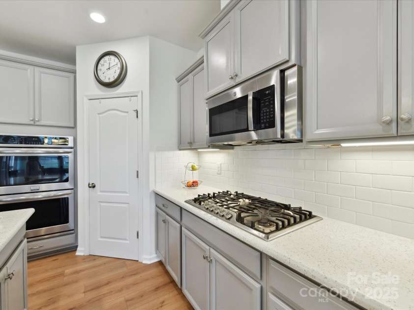 200 Sweet Briar Drive, Indian Land, SC 29707.  MLS# CAR4265722, YatesRealty ID 35484. A gas cooktop, double ovens, pull-out drawers within the cabinetry & a walk-in pantry are other highlights.