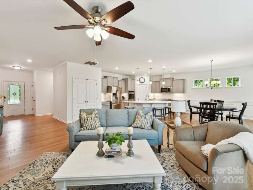 200 Sweet Briar Drive, Indian Land, SC 29707.  MLS# CAR4265722, YatesRealty ID 35484. The family room with ceiling fan above is open to the kitchen, dining area and the sunroom.