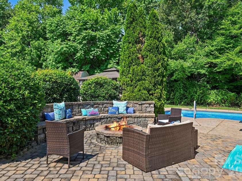 5700 Verducci Lane, Waxhaw, NC 28173.  MLS# CAR4392048, YatesRealty ID 35497. Paver patio flows from the back doors to the firepit area and the pool deck.