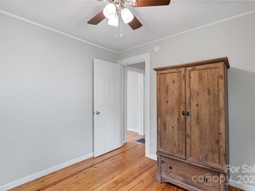 364 State Street, Asheville, NC 28806.  MLS# CAR4294913, YatesRealty ID 35499. Bedroom 1, new ceiling fan, refinished floors, fresh paint and wardrobe conveys for storage