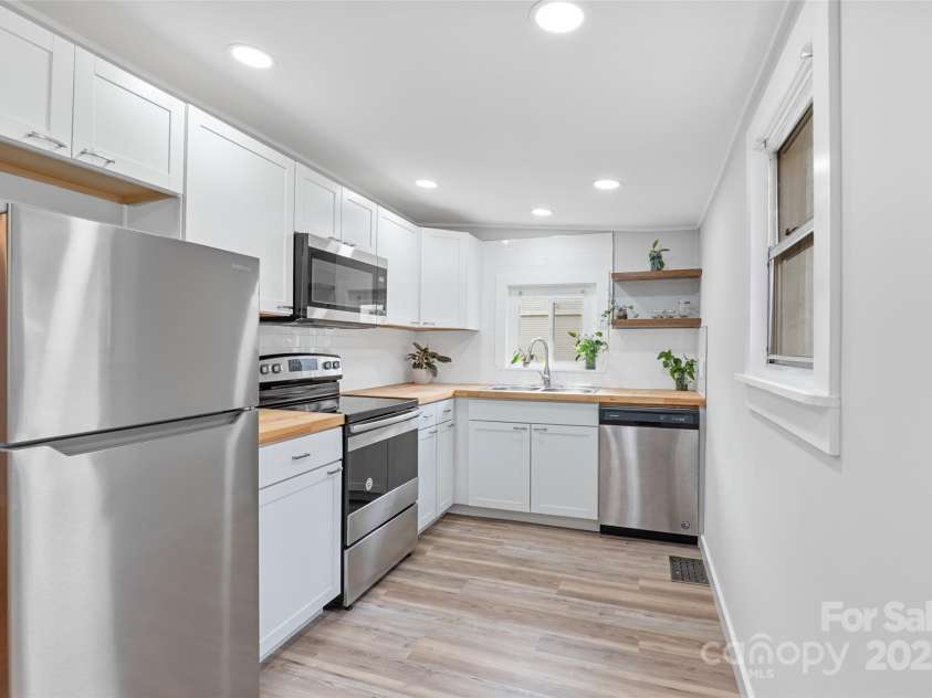 364 State Street, Asheville, NC 28806.  MLS# CAR4294913, YatesRealty ID 35499. Remodeled kitchen with Butcher block countertops, stainless appliances and luxury vinyl plank floors