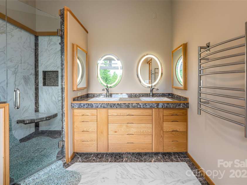 315 Earlys Mountain Road, Leicester, NC 28748.  MLS# CAR4295001, YatesRealty ID 35531. Primary en-suite bathroom with dual vanity, walk-in shower and jacuzzi tub.