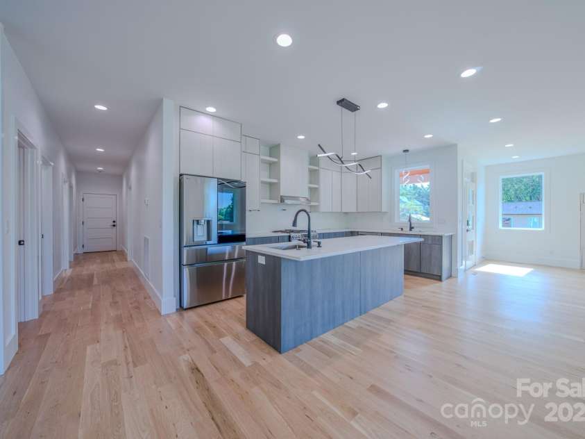 133 Grove Street, Asheville, NC 28801.  MLS# CAR4286313, YatesRealty ID 35540. Kitchen view and hallway leading towards garage, suite, laundry/pantry and half bath. 