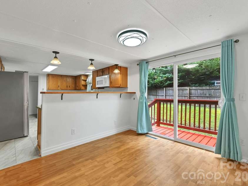 10 Canyon Cove, Candler, NC 28715.  MLS# CAR4400495, YatesRealty ID 35575. Dining Area Opens to Rear Deck