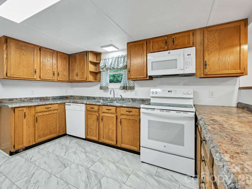 10 Canyon Cove, Candler, NC 28715.  MLS# CAR4400495, YatesRealty ID 35575. Kitchen Sink Overlooks Backyard