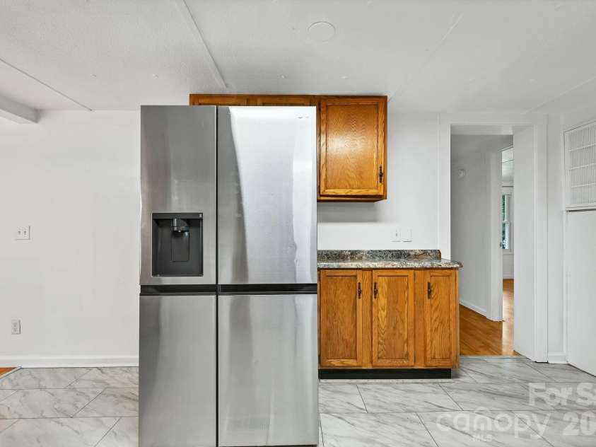 10 Canyon Cove, Candler, NC 28715.  MLS# CAR4400495, YatesRealty ID 35575. Refrigerator and Additional Counter/Cabinet