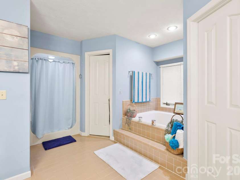 446 Silver Fox Lane, Pisgah Forest, NC 28768.  MLS# CAR4360860, YatesRealty ID 35629. Primary Shower & Double Walk-in Closets