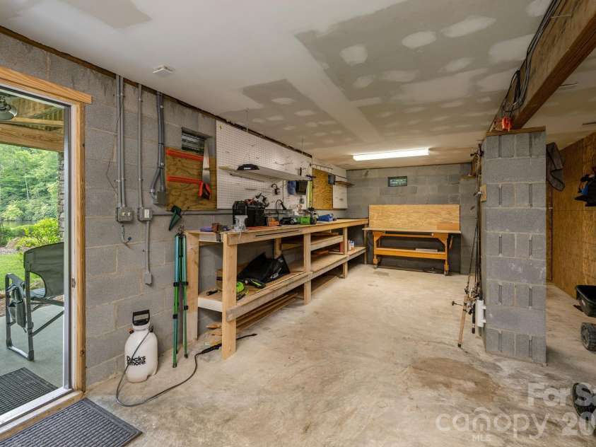 763 Deerlake Road, Brevard, NC 28712.  MLS# CAR4390981, YatesRealty ID 35678. Handy Workshop with utility sink in crawlspace