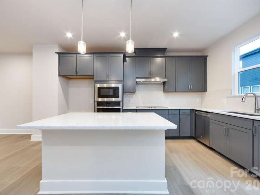 6012 Pivot Court, Charlotte, NC 28205.  MLS# CAR4357047, YatesRealty ID 35686. Gourmet kitchen with large windows