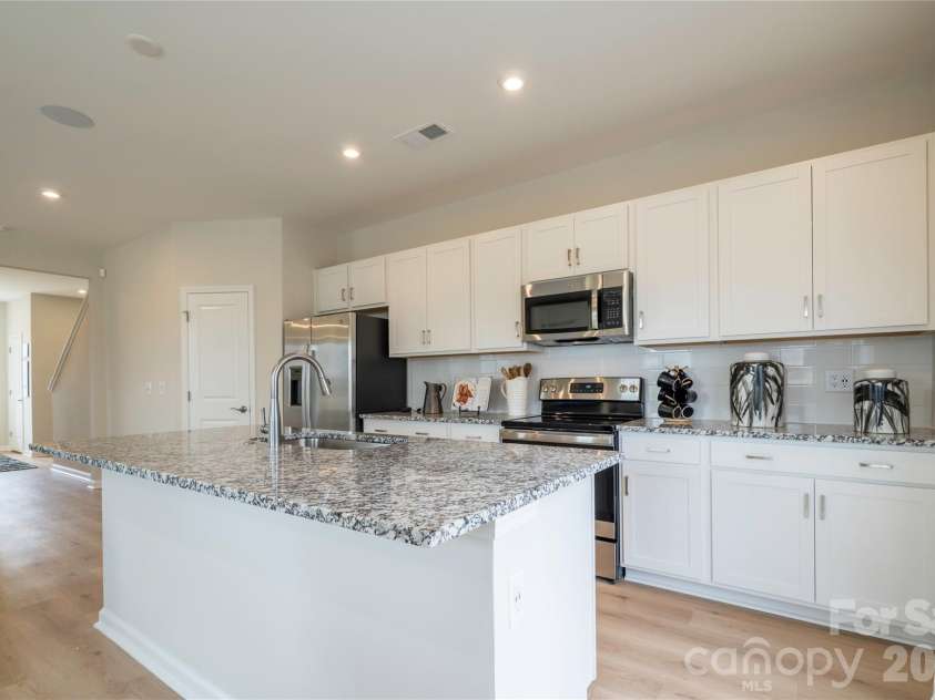 6041 Longar Lane, Charlotte, NC 28269.  MLS# CAR4400027, YatesRealty ID 35687. Kitchen with white cabinets and granite countertops