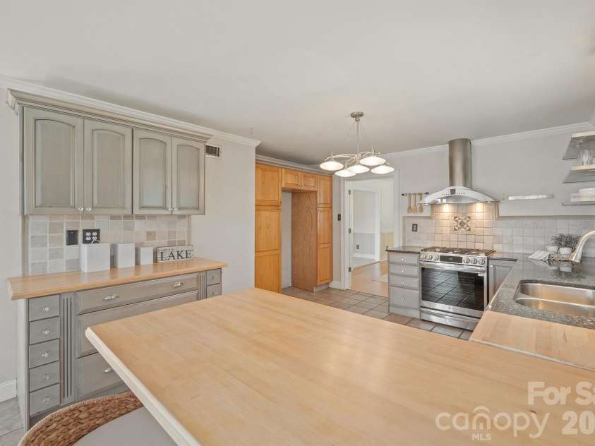 20919 Island Forest Drive, Cornelius, NC 28031.  MLS# CAR4428890, YatesRealty ID 3569. Breakfast bar toward yoru refrigerator spot which has pull out drawers for panrty space on either side