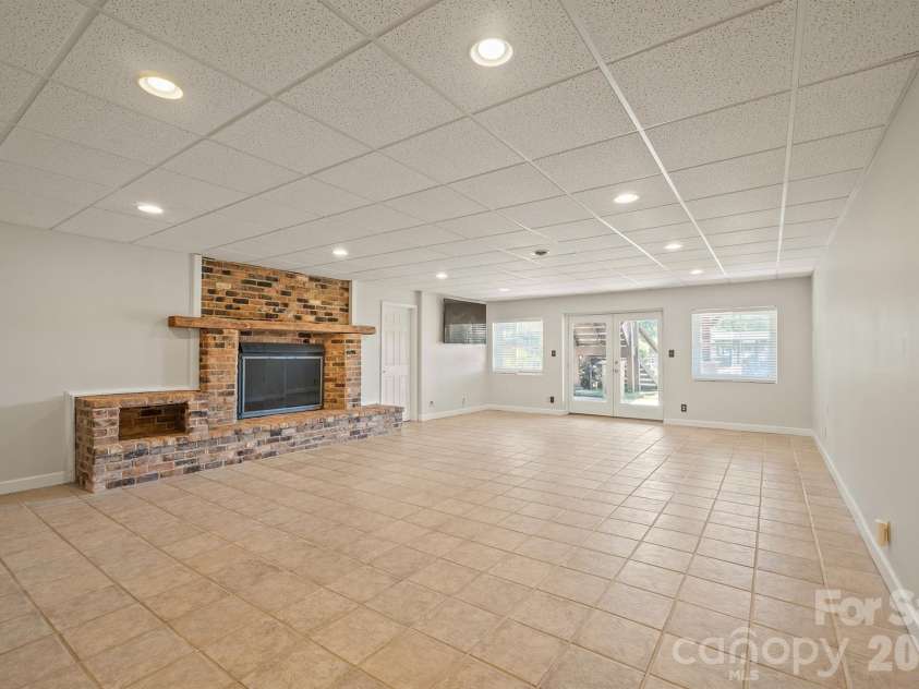 20919 Island Forest Drive, Cornelius, NC 28031.  MLS# CAR4428890, YatesRealty ID 3569. Down to your basement with second Brick fp and gas logs tiled flooring and easy outdoor acess