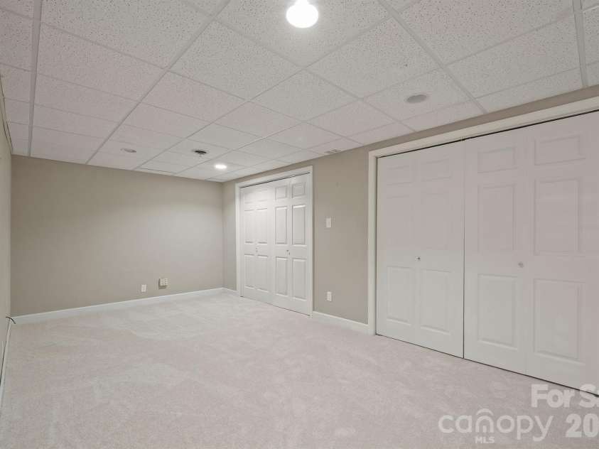 20919 Island Forest Drive, Cornelius, NC 28031.  MLS# CAR4428890, YatesRealty ID 3569. Flex room behind stairway to basement can be additional sleeping quarters or that pefect movie room or game room