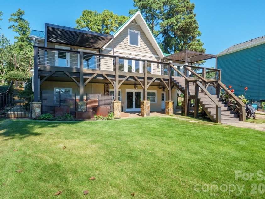 20919 Island Forest Drive, Cornelius, NC 28031.  MLS# CAR4428890, YatesRealty ID 3569. Lush backyard ready for entertaining and full bottom patio is covered from the elements with french doors to basement den or party room