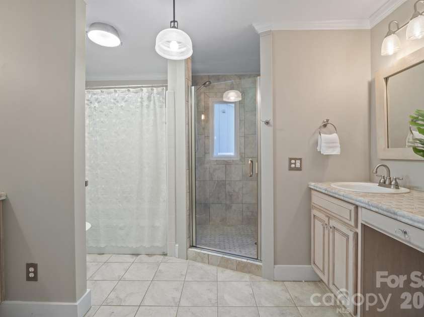 20919 Island Forest Drive, Cornelius, NC 28031.  MLS# CAR4428890, YatesRealty ID 3569. Primary bath has dual vanities and 3 shower heads