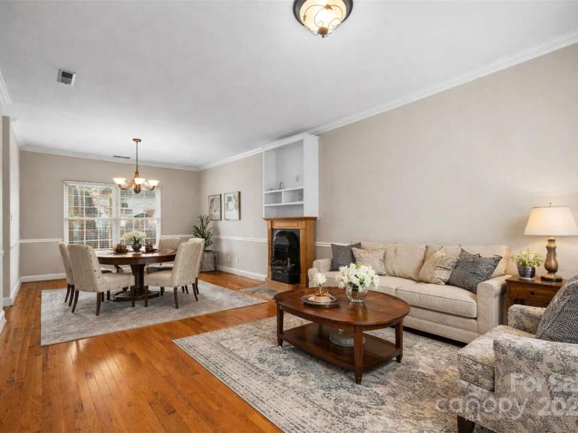 112 Fransher Lane, Mooresville, NC 28117.  MLS# CAR4331248, YatesRealty ID 3573. Living & dining room combo has a cozy gas fireplace.  (virtually staged)