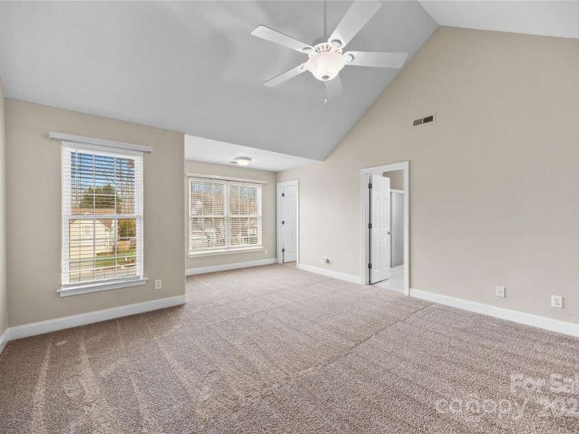 112 Fransher Lane, Mooresville, NC 28117.  MLS# CAR4331248, YatesRealty ID 3573. Vaulted ceiling primary bedroom with 2 walk-in closets and en suite primary bath