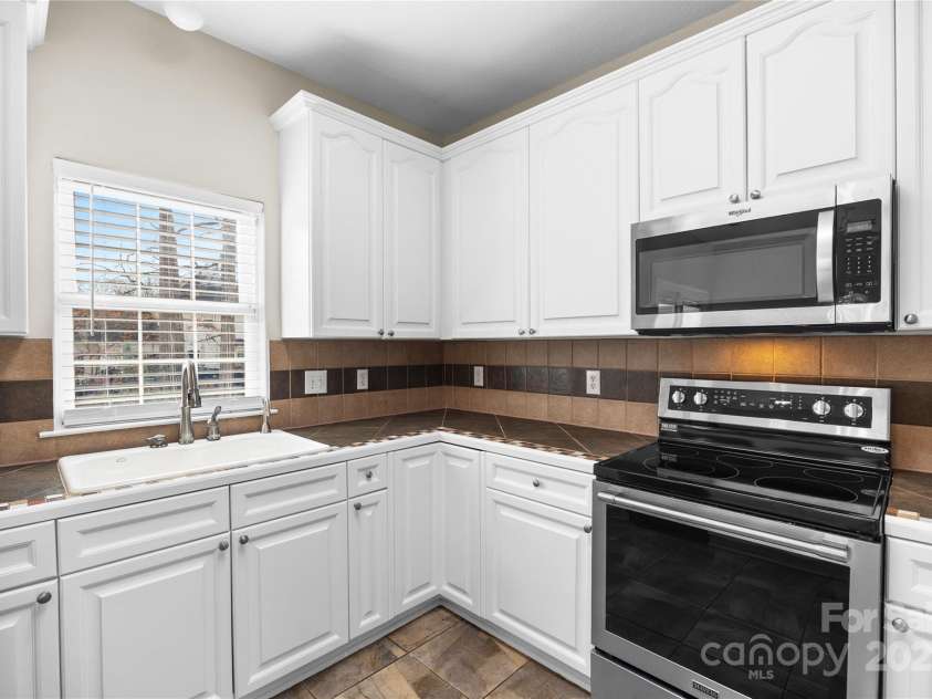 112 Fransher Lane, Mooresville, NC 28117.  MLS# CAR4331248, YatesRealty ID 3573. White cabinets, SS appliances, tile counter tops and 3 pantries. 