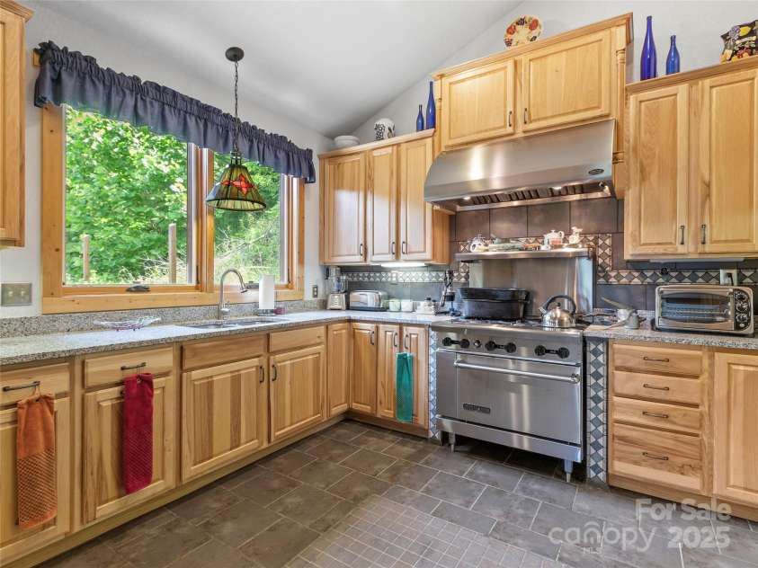 263 Wolf Mountain Road, Green Mountain, NC 28740.  MLS# CAR4148202, YatesRealty ID 3574. Kitchen w/stainless steel appliances & gas range